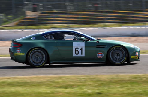 A racing Aston blurs past.